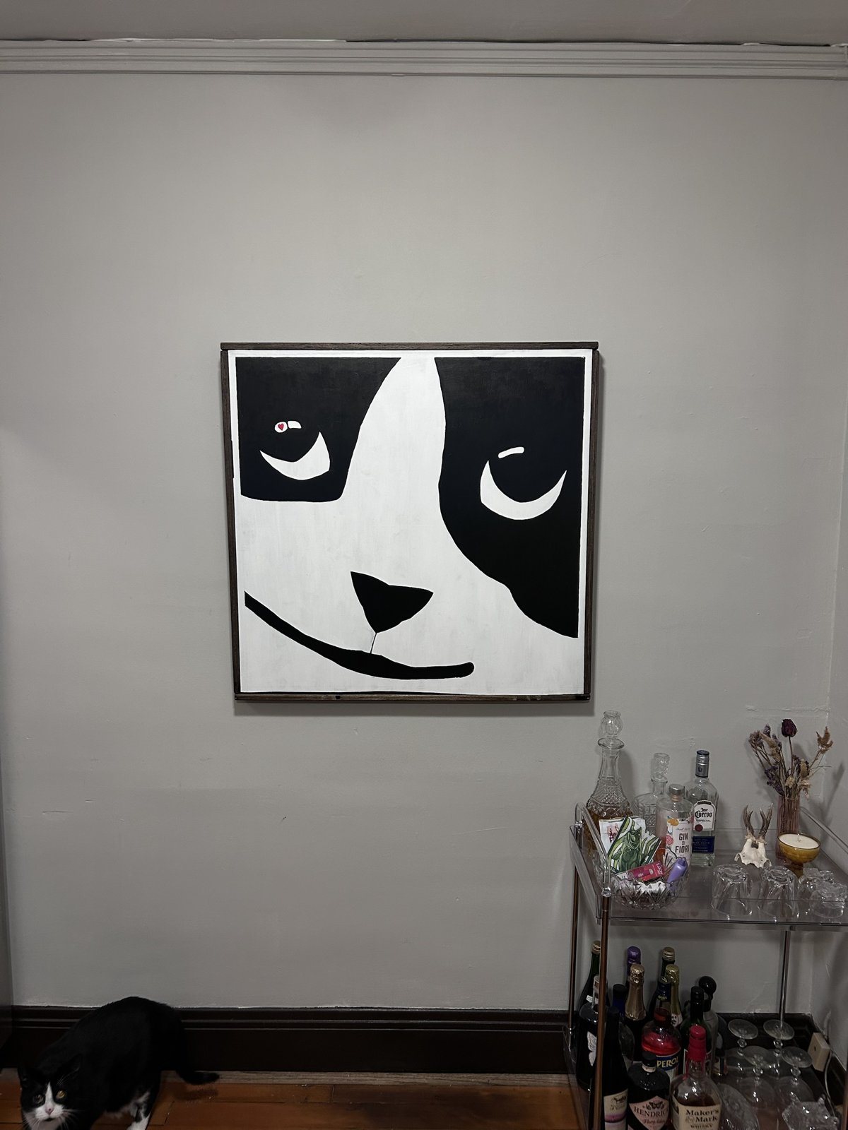 Black and white close-up painting of a face with a heart in one eye